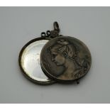 A 19th century Continental white metal pendant enclosing a mirror. 4.5 cm wide.