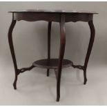 An Edwardian carved walnut serpentine side table. 76 cm wide.