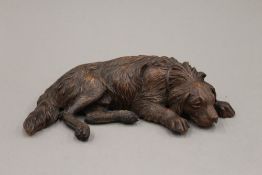 A Black Forest carved wooden model of a dog. 29 cm wide.