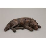 A Black Forest carved wooden model of a dog. 29 cm wide.