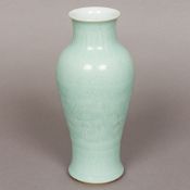 A Chinese porcelain vase Of slender baluster form, with all over celadon glaze,