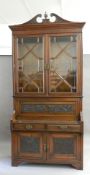 A Victorian walnut bookcase cabinet. 256 cm high.