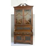 A Victorian walnut bookcase cabinet. 256 cm high.