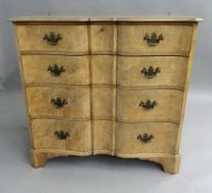 A mid-20th century walnut serpentine chest of drawers. 92 cm wide.