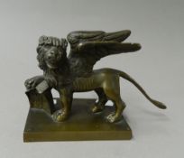 A Victorian bronze model of a winged lion. 19 cm long.