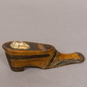 A 19th century treen snuff shoe Of typical form with brass line and pique inlays,