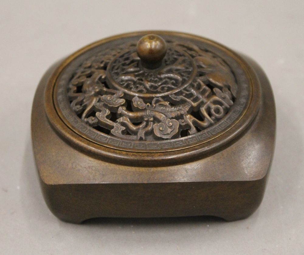 A Chinese bronze pierced topped censer. 8.5 cm wide.