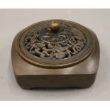 A Chinese bronze pierced topped censer. 8.5 cm wide.