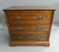 An Edwardian walnut dressing chest. 92 cm wide.