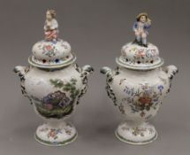 Two Continental tin glazed covered urns. 31 cm high.