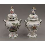 Two Continental tin glazed covered urns. 31 cm high.
