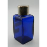 A silver topped blue glass scent bottle
