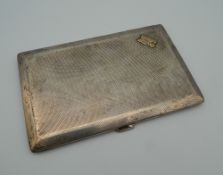 A silver cigarette case. 14 cm wide (221.9 grammes total weight).