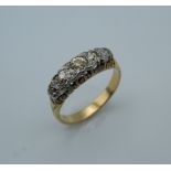 An 18 ct gold five stone diamond ring. Ring Size K/L (3.