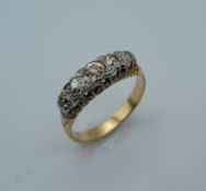 An 18 ct gold five stone diamond ring. Ring Size K/L (3.