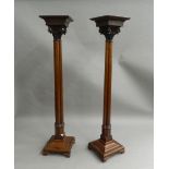 A pair of mahogany torcheres. 160 cm high.