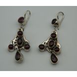 A pair of silver and garnet earrings. 4.5 cm high.