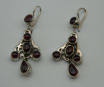 A pair of silver and garnet earrings. 4.5 cm high.