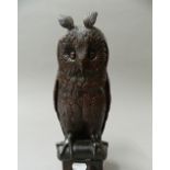 A Black Forest type carved wooden model of an owl. 31 cm high.