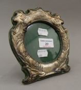 An Art Nouveau silver photograph frame, inscribed ''There's Rosemary That's For Remembrance''.