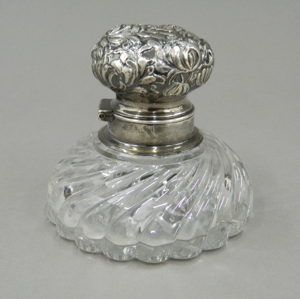 A silver topped inkwell. 8.5 cm wide.