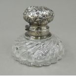 A silver topped inkwell. 8.5 cm wide.