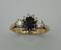 An 18 ct gold sapphire and diamond ring. Ring Size P (5.