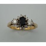 An 18 ct gold sapphire and diamond ring. Ring Size P (5.