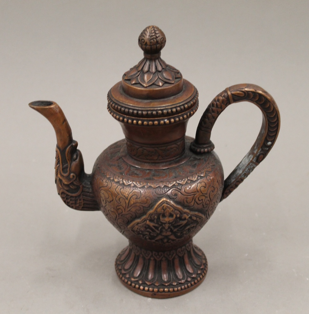 A Tibetan style copper tea pot. 20 cm high.