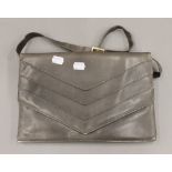A Mario Valentino grey handbag. 31 cm wide.
