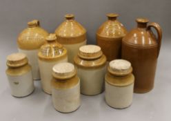 A quantity of stoneware flagons and crocks. The largest 34 cm high.