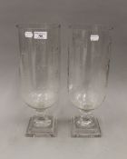 A pair of cut glass storm lamps. 40.5 cm high.