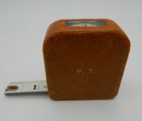 An Asprey leather cased tape measure. 5.5 cm wide.