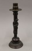 A Japanese patinated bronze candlestick decorated with a dragon. 24.5 cm high.