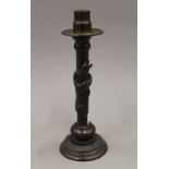 A Japanese patinated bronze candlestick decorated with a dragon. 24.5 cm high.