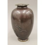 A Japanese bronze vase decorated with fish. 23 cm high.