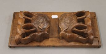 A wooden book slide carved with elephants. 35.5 cm long.