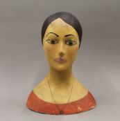 A late 19th/early 20th century papier mache mannequin head. 34 cm high, 27.5 cm wide, 18 cm deep.