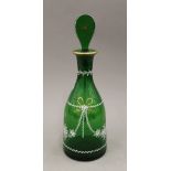 An enamel and gilt decorated green glass decanter. 33.5 cm high.