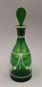 An enamel and gilt decorated green glass decanter. 33.5 cm high.