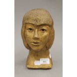 A gold painted terracotta bust of a girl. 22.5 cm high.