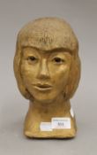 A gold painted terracotta bust of a girl. 22.5 cm high.