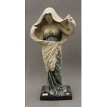 A large pottery model of a semi clothed woman. 64 cm high.