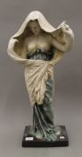 A large pottery model of a semi clothed woman. 64 cm high.