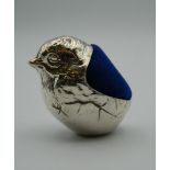 A silver pin cushion formed as a chick. 4.5 cm high.