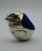 A silver pin cushion formed as a chick. 4.5 cm high.