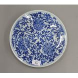 A late 19th century Chinese porcelain blue and white dish painted with three flower heads and