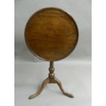 A 19th century oak and mahogany tilt-top tripod table. 53.5 cm diameter.