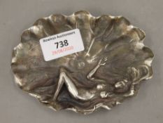 A Chinese white metal dish depicting a girl. 12.5 cm wide.