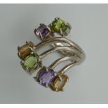 A silver amethyst and peridot ring. Ring Size N.